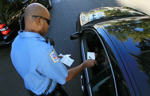 Officer Tyrone Gross hands out a warning to a motorist who was talking on his cell phone on Sept. 21 in Washington, D.C. Photo by Mark Wilson/Getty Images