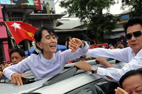 Myanmar opposition leader Aung San Suu Kyi waves to a crowd after speaking to journalists and supporters on Monday in Yangon; Soe Than WIN/AFP/Getty Images