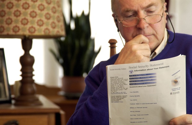 A man examines his Social Security paperwork.