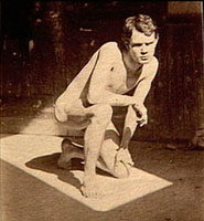 Photograph of Male nude crouching in sunlit rectangle in Pennsylvania Academy studio 